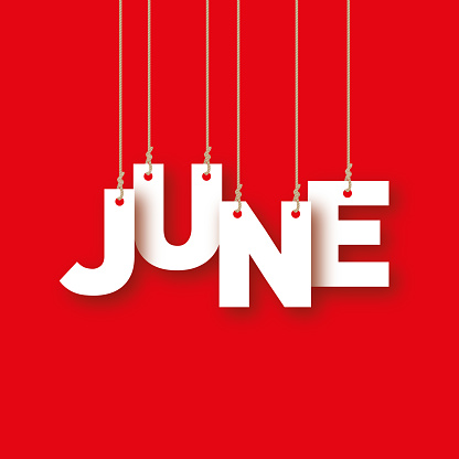 JUNE the word of the white letters hanging on the ropes on a red background