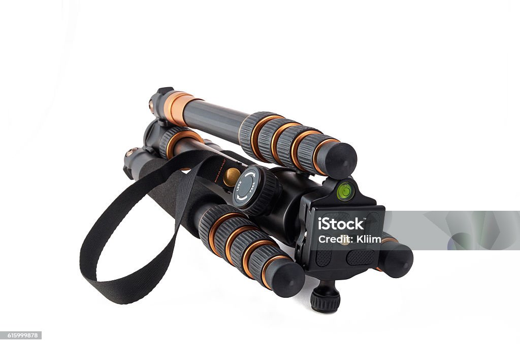 lightweight travel tripod collapsed travel tripod of carbon with twist locks lying on white background Aluminum Stock Photo