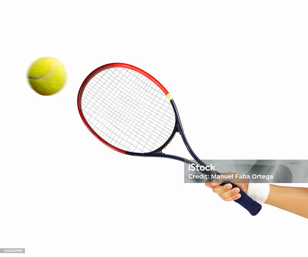 hitting a tennis ball hand holding a tennis racket hitting a ball isolated on white background Tennis Racket Stock Photo