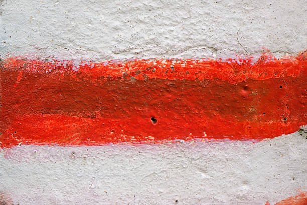 istock Red and white stripes painted on wall 616001166