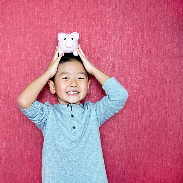 A vibrant pink piggy bank against a white background, symbolizing saving and financial management for children.