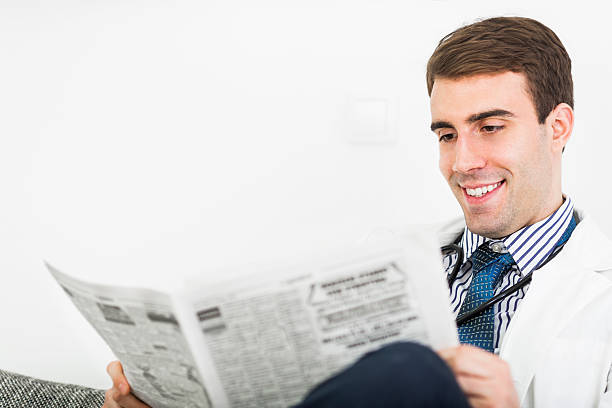 istock Doctor reading newspapers 616002310