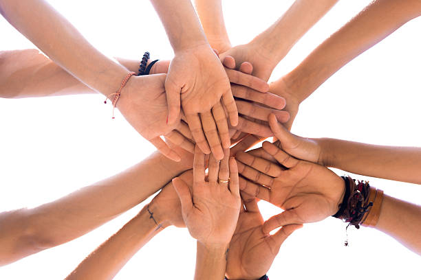 istock Group of friends putting hands together 616002482