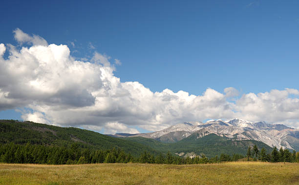 istock Blue sky and cumulus clouds over the Eastern Sayan Mountains 616003536