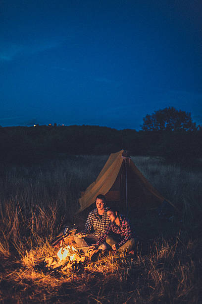 istock Couple preparing sausages on bonfire 616004472