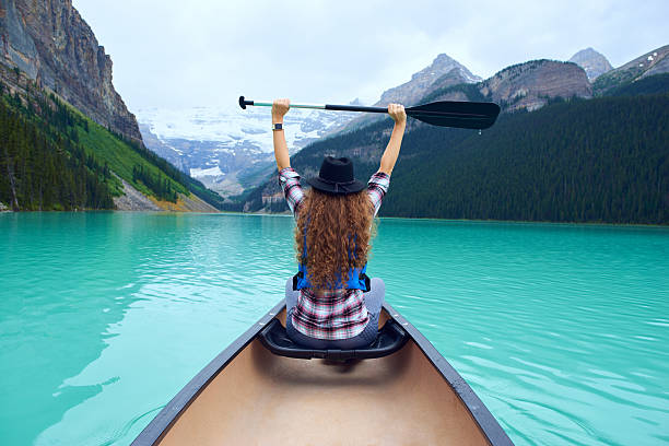 istock Woman in the boat over beautiful nature environment 616005706