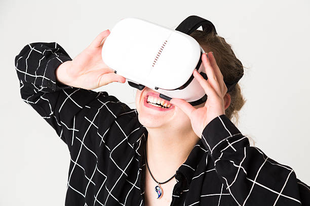 istock Blonde girl in head-mounted display laughing 616008180