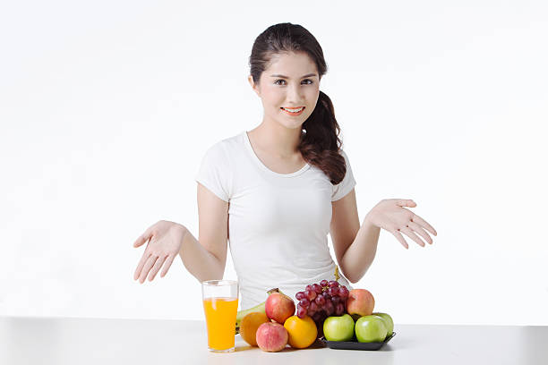 istock beautiful woman with healthy food, white background isolate 616012408