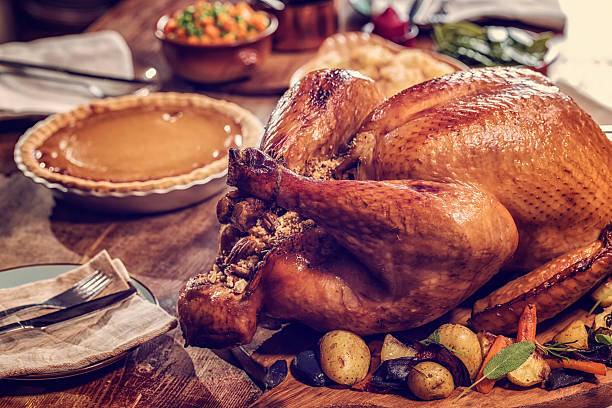 Stuffed Turkey and Pumpkin Pie Traditional Stuffed Turkey with side dishes pecan and pumpking pie for holiday dinner roast turkey stock pictures, royalty-free photos & images