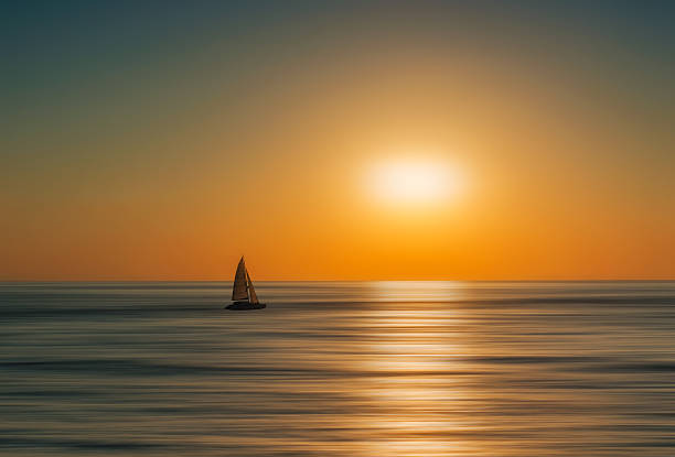 istock Silhouette of a boat at sunrise. Artistic blur effect added 616013646