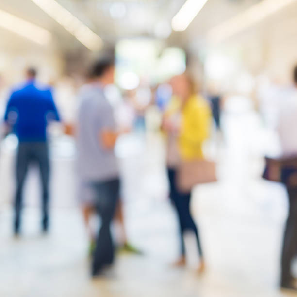 istock Abstract blurred people socializing during coffee break at business conference. 616014018