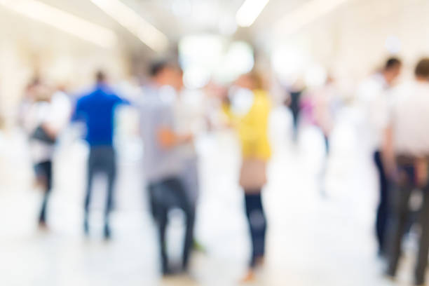 istock Abstract blurred people socializing during coffee break at business conference. 616014136