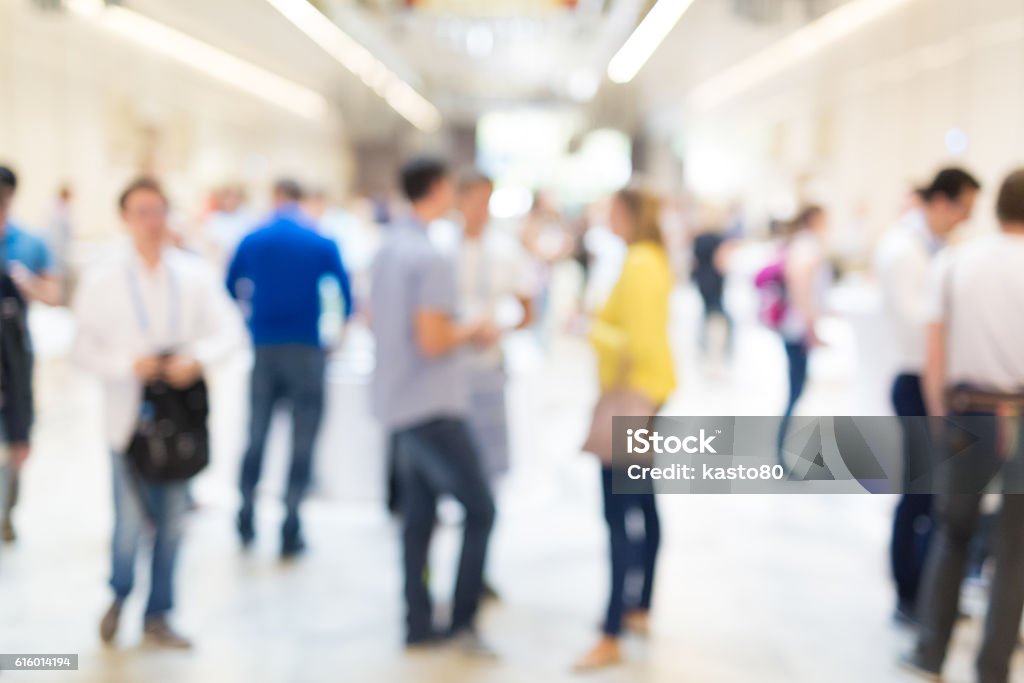 Abstract blurred people socializing during coffee break at business conference. Abstract blurred people socializing during coffee break at business meeting or conference. Exhibition Stock Photo