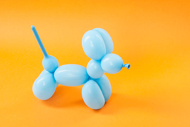 istock Blue balloon dog on orange 616015034