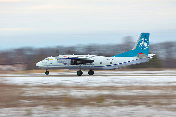 Antonov An-26 takeoff Kiev Region, Ukraine - January 31, 2011: Antononv An-26 cargo plane is taking off from the runway in snow storm antonov an 26 stock pictures, royalty-free photos & images