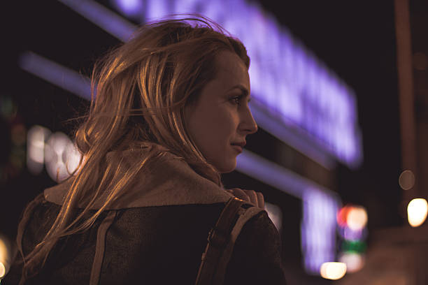 istock Woman walking down the street on cold night 616017606