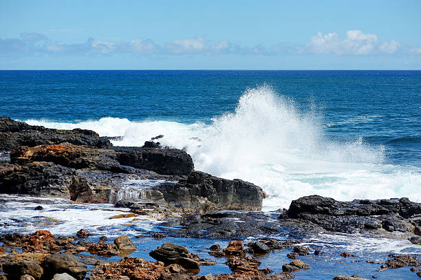 istock Ocean waves crashing on rocks 616019160