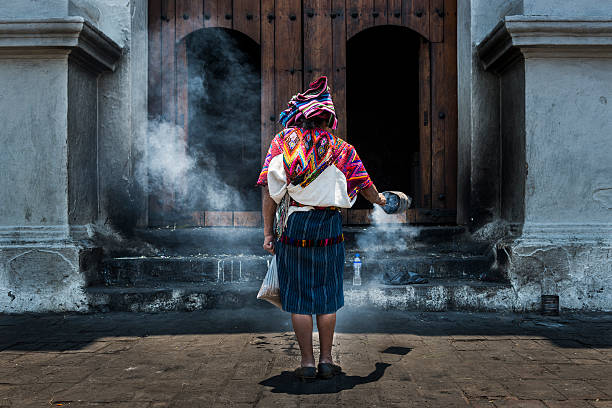 Chichicastenango, Guatemala - April 26, 2014: Mayan woman performing a ritual in front of the Santo Tomás church in the town of Chichicastenango, in Guatemala