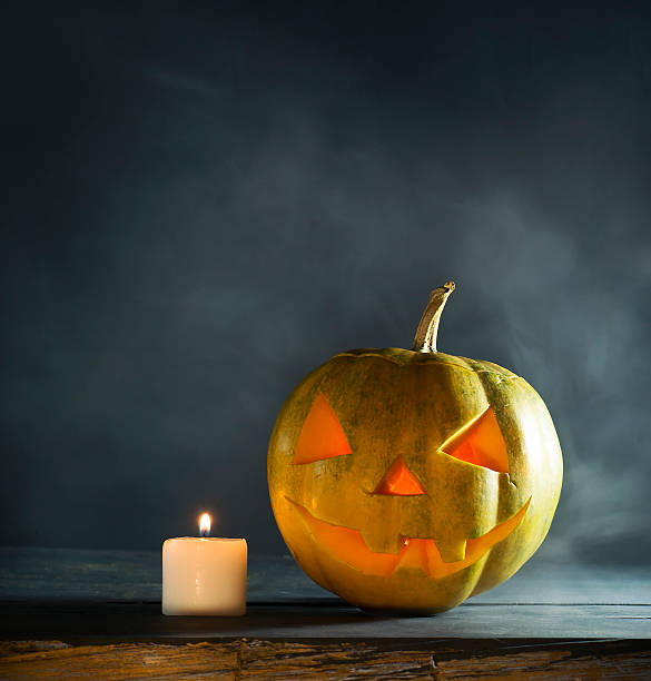 istock Halloween pumpkin with candles and smoke 616020754