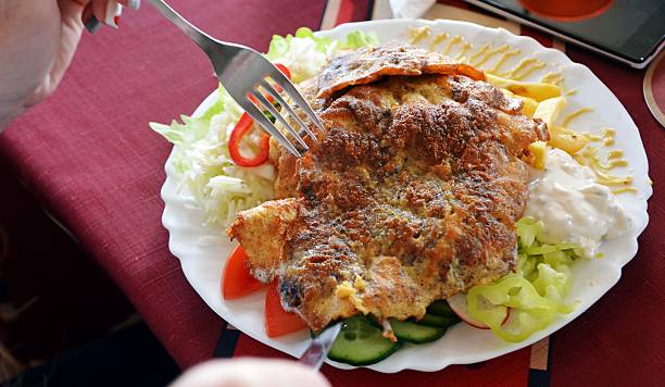 istock Chicken breast coated in batter and fries on a plate 616021062