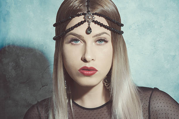 portrait of retro fashion model with blond hair wearing black luxurious jewelry, looking at camera.horizontal shot.