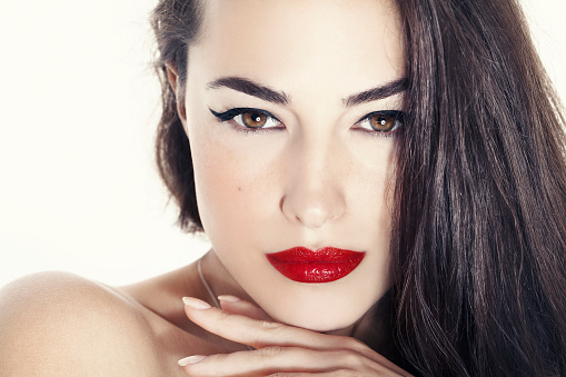 woman portrait with red lips and black eyeliner, beauty closeup
