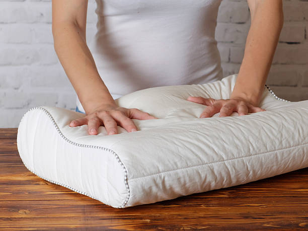 istock Woman chooses a pillow to sleep 616090714