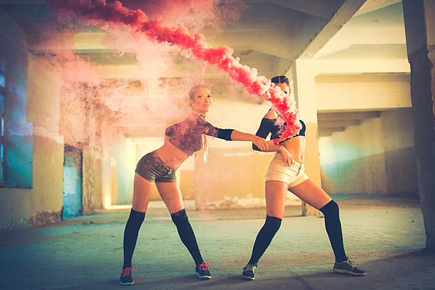 istock Two girls playing with the smoke 616094132