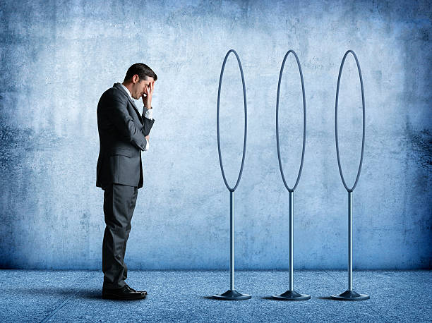 Businessman Thinking About The Hoops He Needs To Jump Through