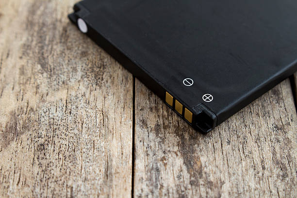 istock battery of smart phone on wood background, soft focused 616095776