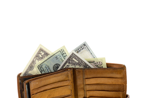 natural leather wallet isolated on white background. Expensive man's purse closeup. Wallet filled up with money