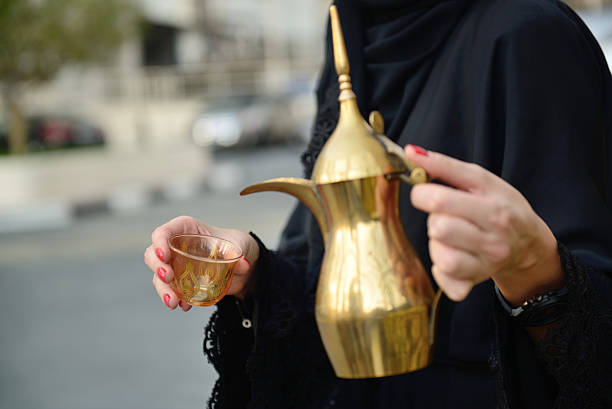 istock Emarati Arab  woman pouring tea 616096860