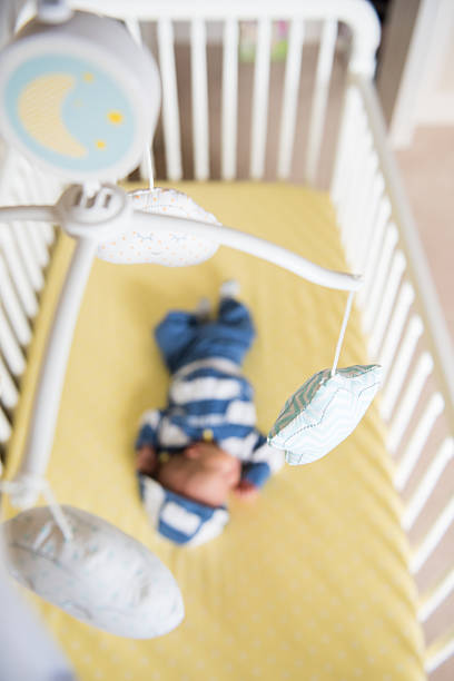 istock Newborn baby boy sleeping in white crib 616098108