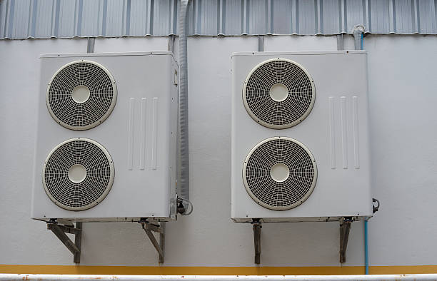 istock group of air conditioner units on wall outside building 616098636