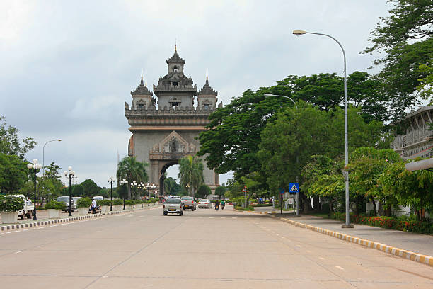 Vientiane, Laos - June 24 2009: Main street in Vientiane with the Triumphal Arch of Patuxai. This war monument is dedicated to those who fought in the struggle for independence from France.