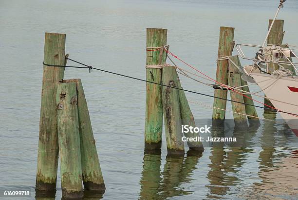 Boat Mooring In A Row By The Sea Stock Photo - Download Image Now - Blue, Bollard, Cleat