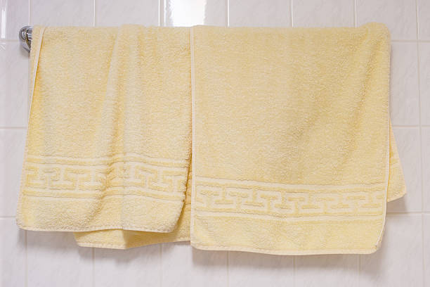 Stripped towels hanging on towel holder in the bathroom.