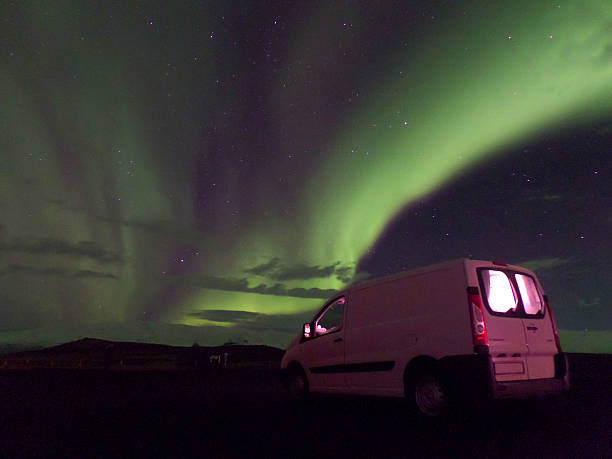 istock Northern Lights Dancing over a White Camper Van, Iceland 616101686