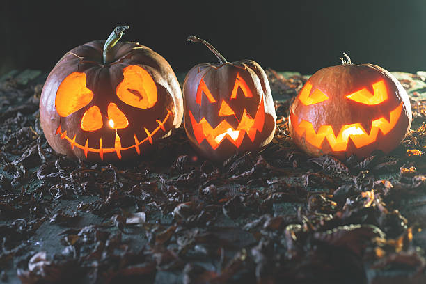 istock Halloween pumpkins at wood background. 616102274