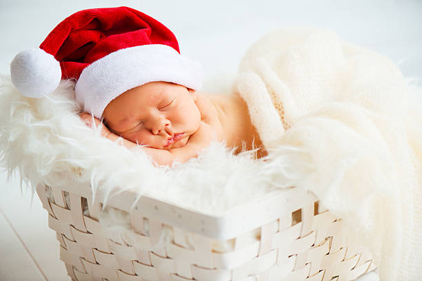 istock sleeper newborn baby in  Christmas Santa cap 616102984