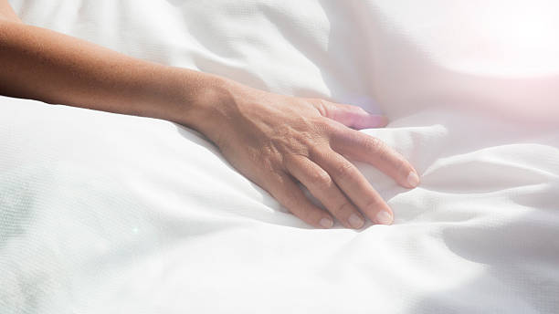 istock closeup of female arm on white bedsheets 616104036