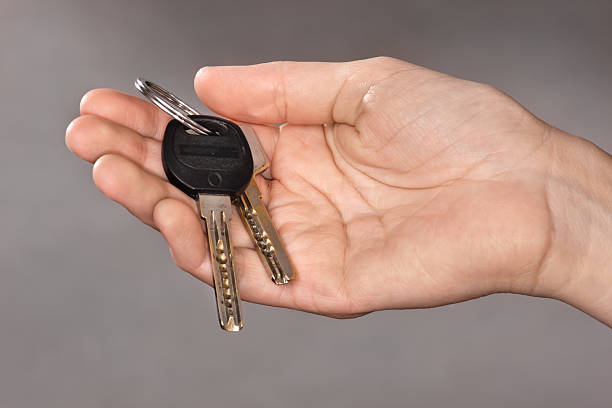 istock hand holding keys from new apartment 616104432