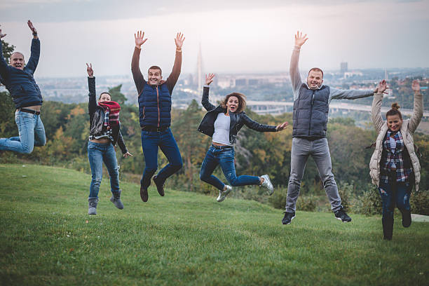 istock large group of people jumping and celebrating 616104874