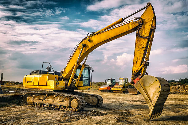 istock Yellow excavator in a new highway construction 616106262