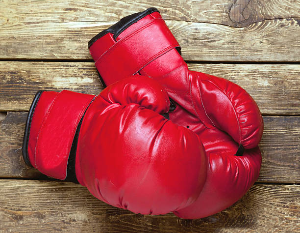 istock pair of boxing gloves on wooden surface 616109444