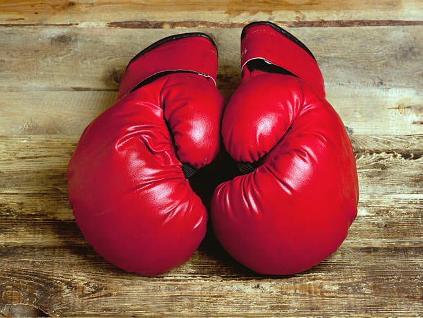 istock pair of boxing gloves on wooden surface 616109506
