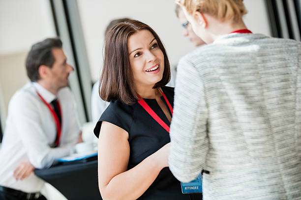 istock Businesswomen talking during coffee break at convention center 616109596