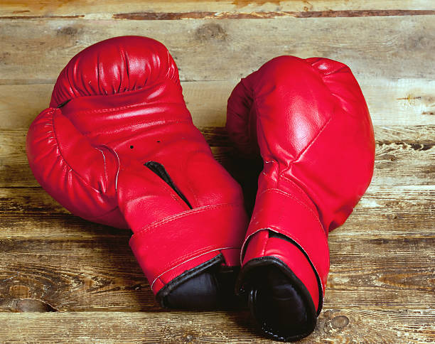 istock pair of boxing gloves on wooden surface 616109656