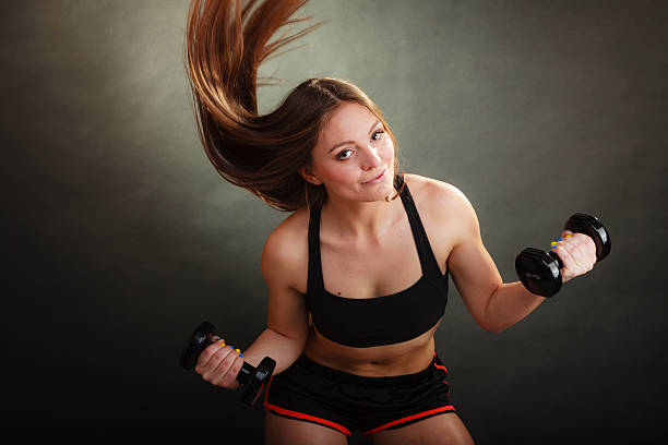 istock Fit woman exercising with dumbbells. 616110978