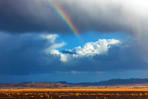 Storm in desert, Sahara desert in the afternoon,Morocco, dark clouds,rainbow in the background.Norh Africa,Nikon D3x